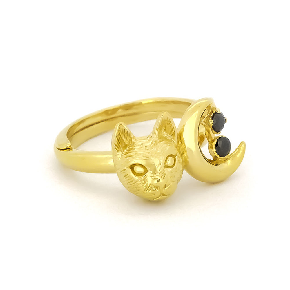 Gold ring featuring a cat head and crescent moon with two black gemstones.