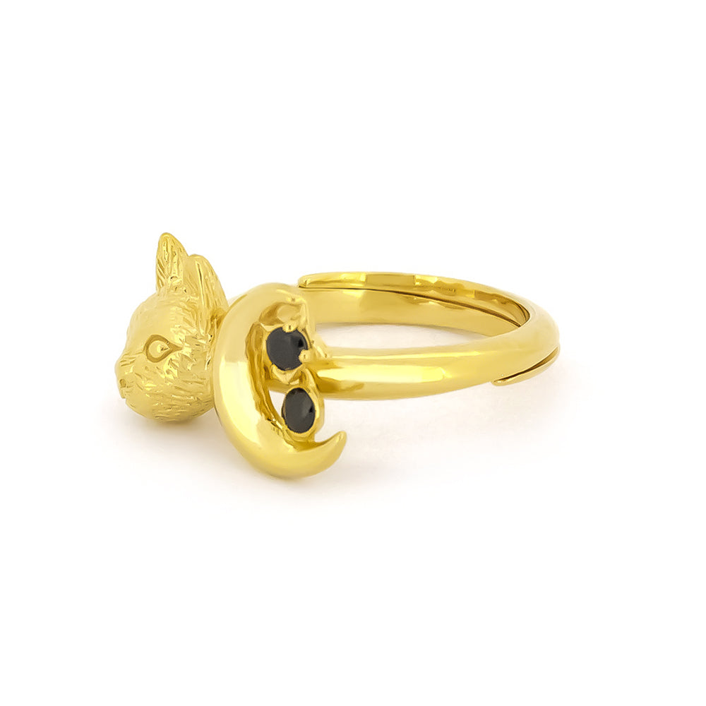 Gold ring featuring a cat head and crescent moon with two black gemstones.