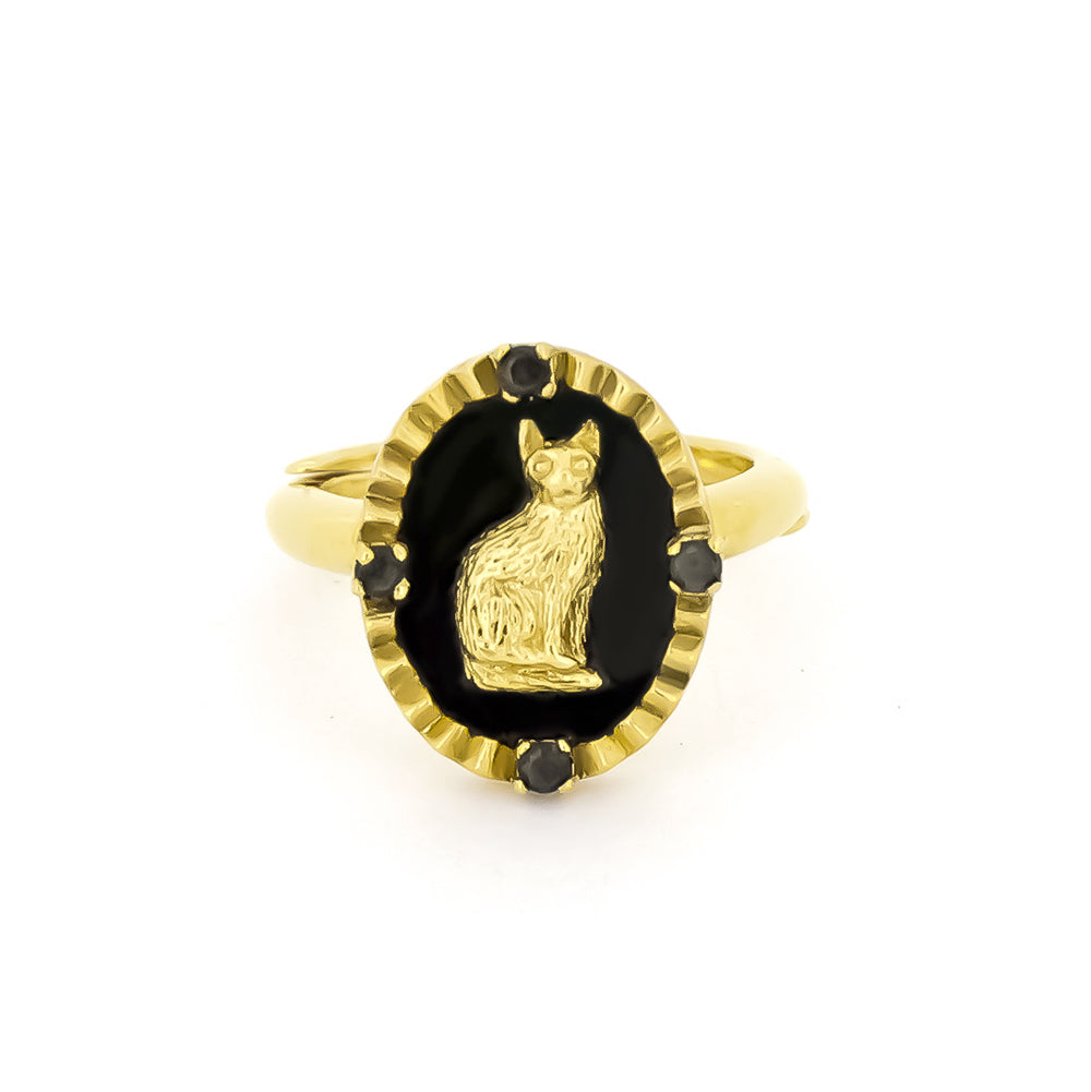 Gold ring featuring a cat design set in a black oval, surrounded by small black gemstones.