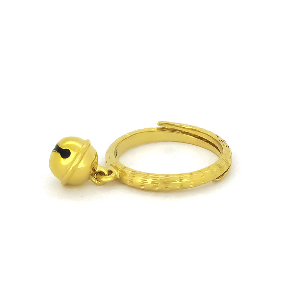 A gold ring featuring a small cat bell charm. 