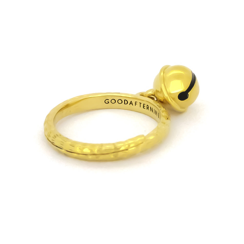 A gold ring featuring a small cat bell charm. 