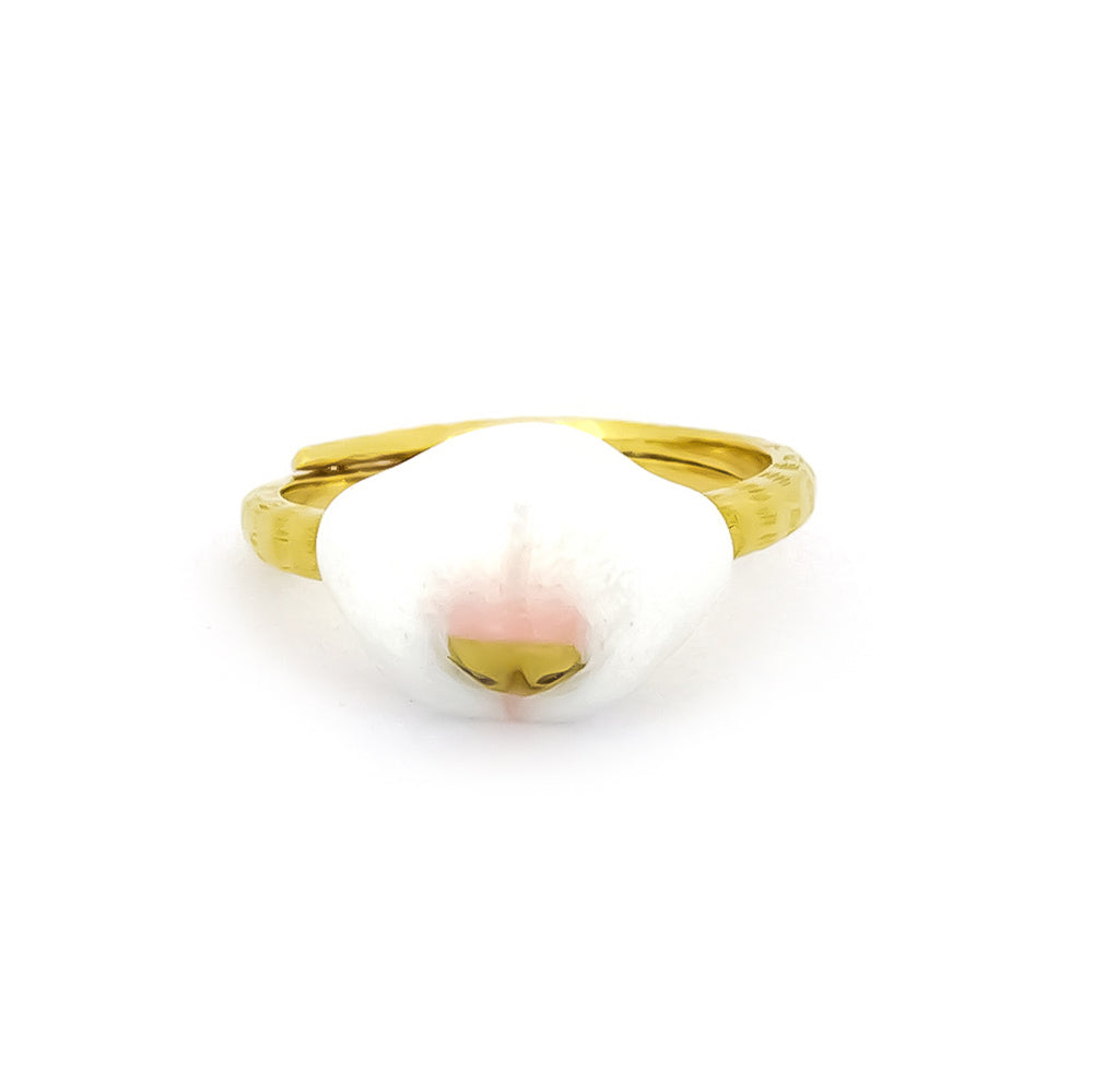 Gold cat ring featuring a white and pink design resembling a cat's nose.