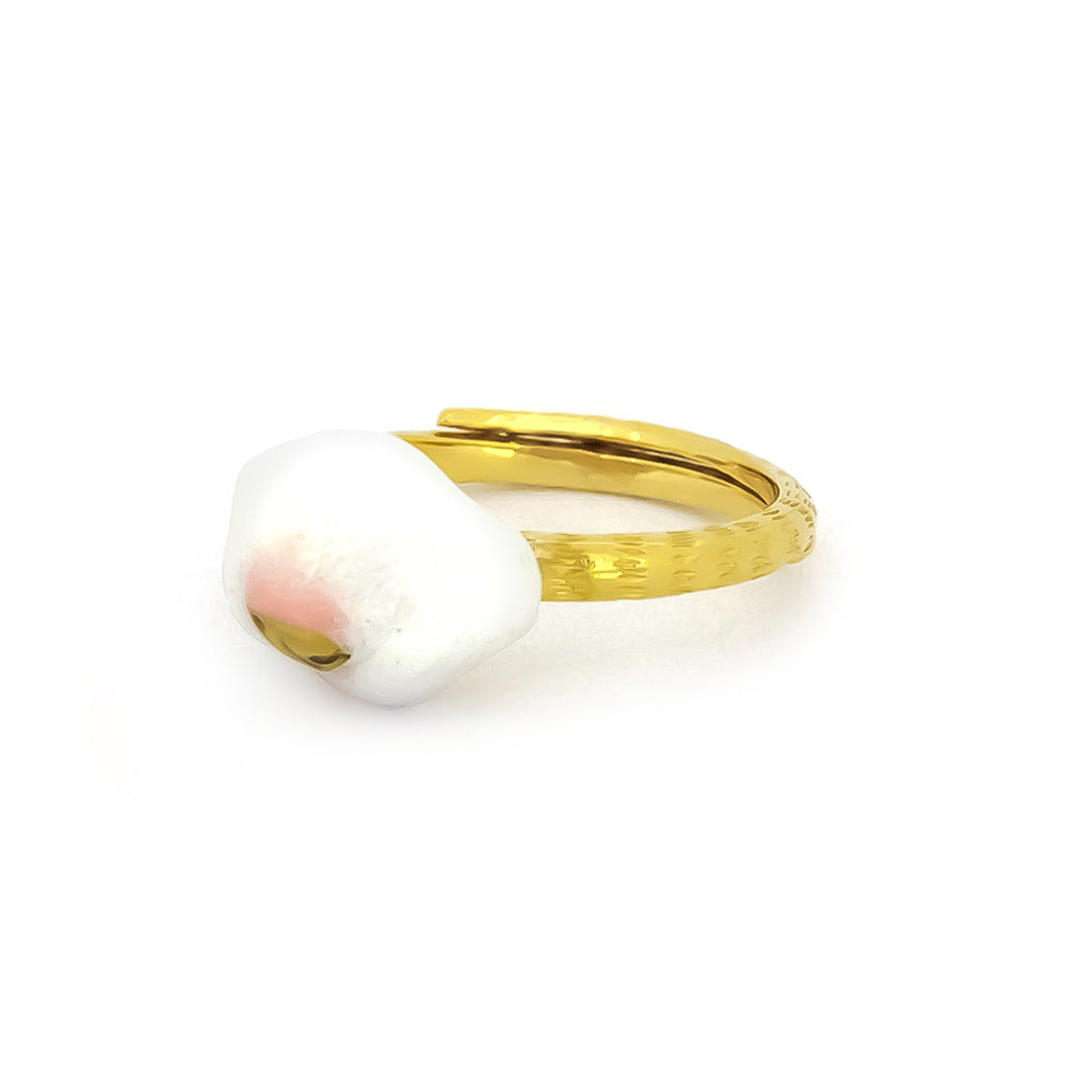 Gold cat ring featuring a white and pink design resembling a cat's nose.