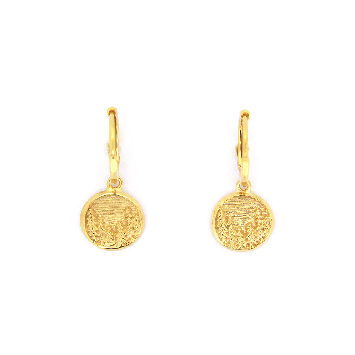 Nature-inspired gold earrings with circular pendants featuring detailed forest scene, showcasing trees and a landscape.