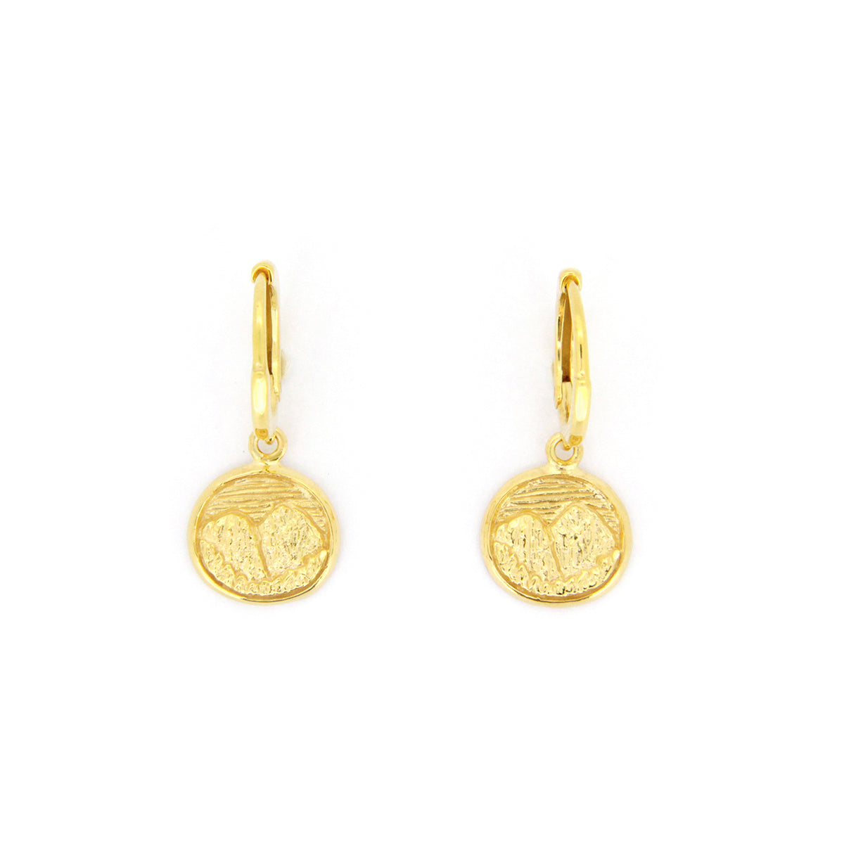 Nature-inspired gold earrings with circular pendants featuring detailed mountain scene.