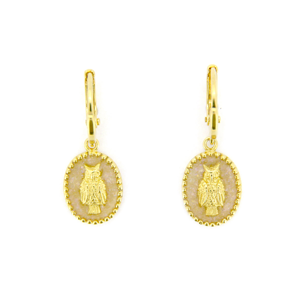 Elegant gold drop earrings with oval charms showcasing a detailed owl design