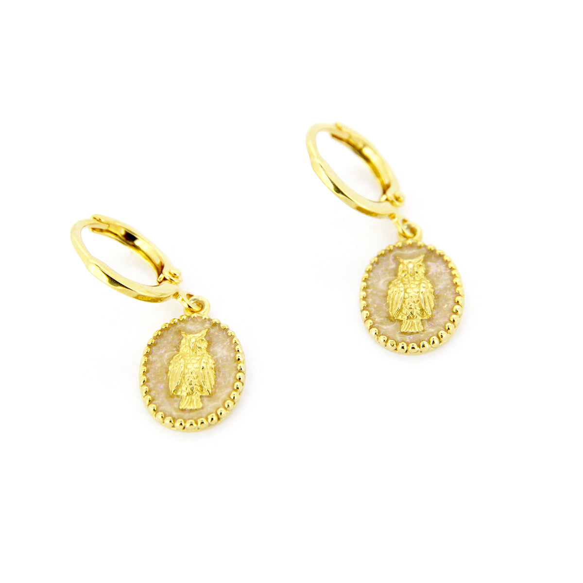 Elegant gold drop earrings with oval charms showcasing a detailed owl design