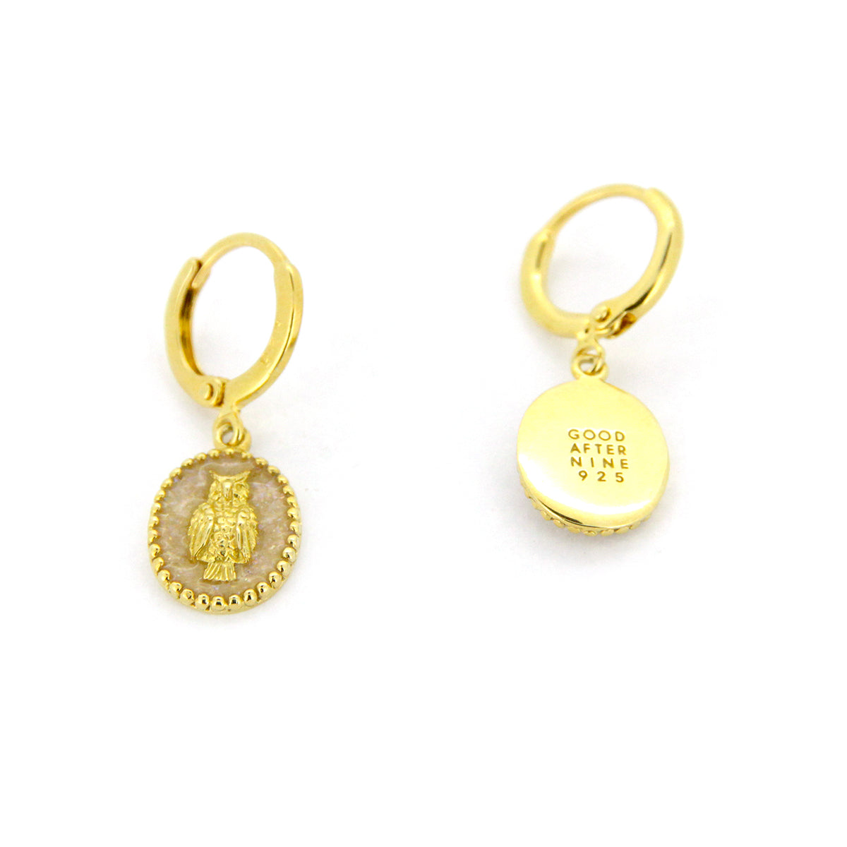 Unique gold earrings with oval charms showcasing a detailed owl design