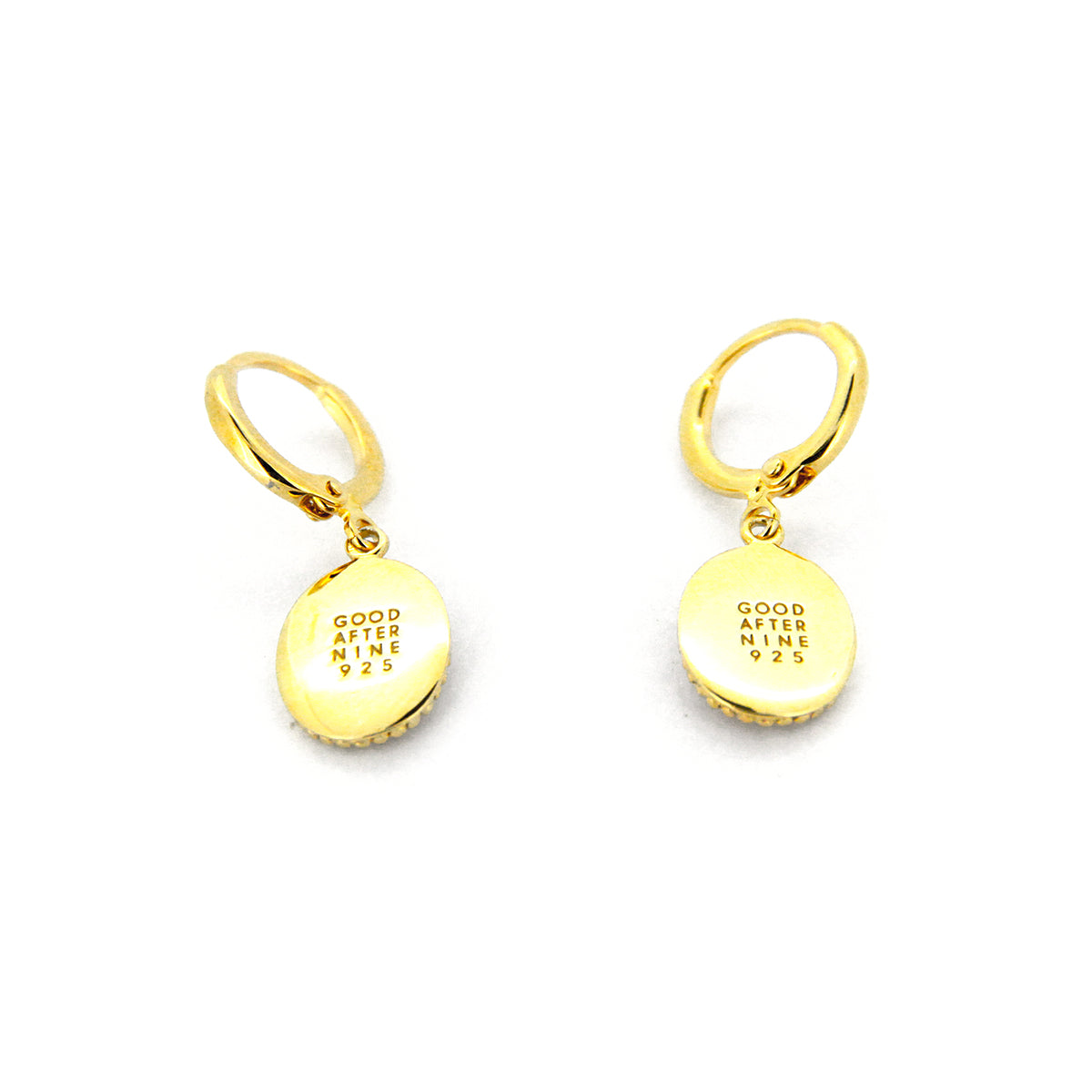 Gold drop earrings with circular pendants inscribed with GOOD AFTER NINE logo.