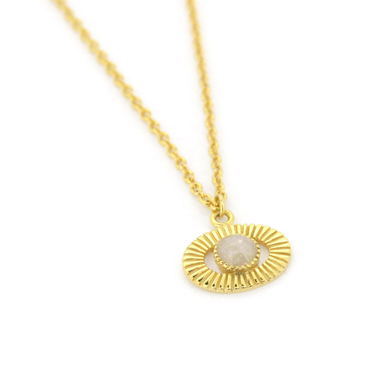 Gold necklace featuring a round pendant with a stone in the center.