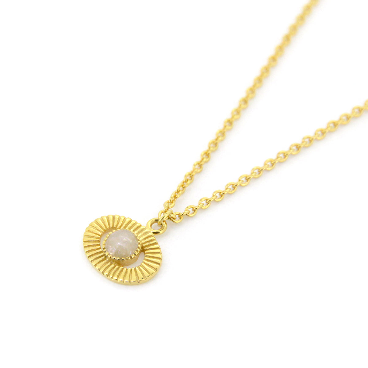 Gold necklace featuring a round pendant with a stone in the center, inspied by moon.