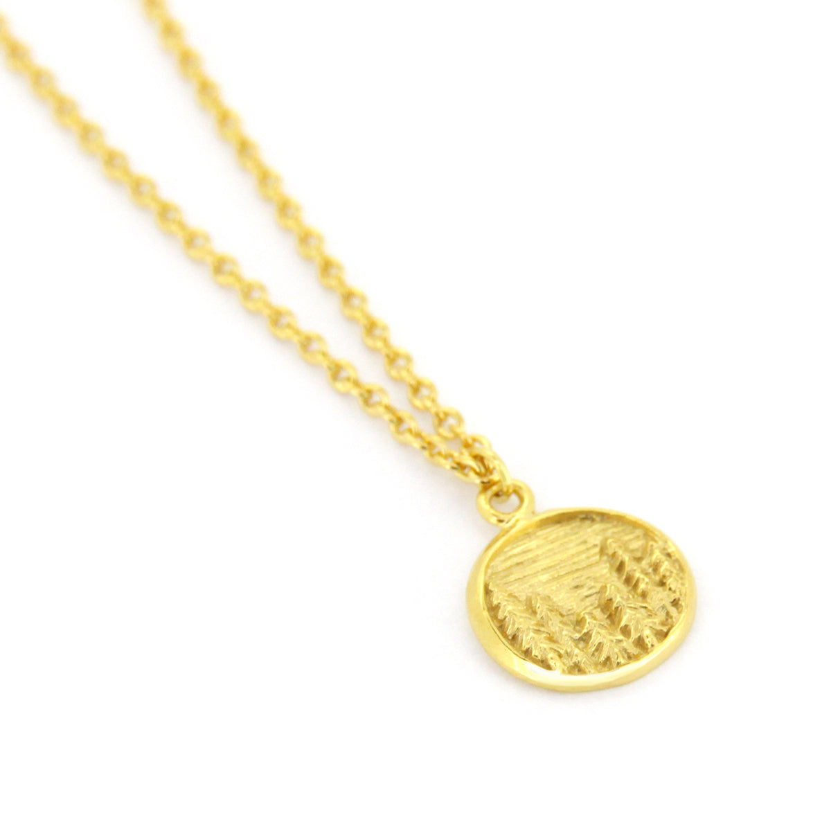 Gold necklace with circular pendants featuring a forest design, perfect for nature lovers.