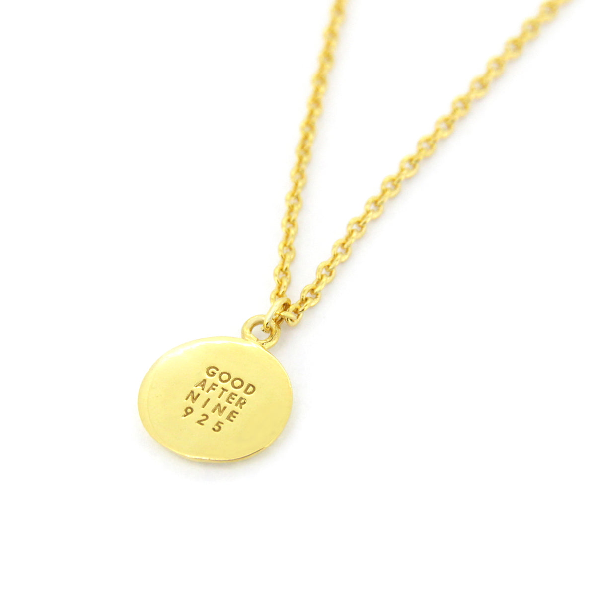 Golden necklace showcasing Good After Nine logo detail.