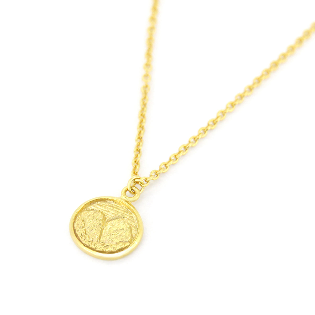 Beautifully crafted gold necklace with circular pendants featuring detailed mountain scene.