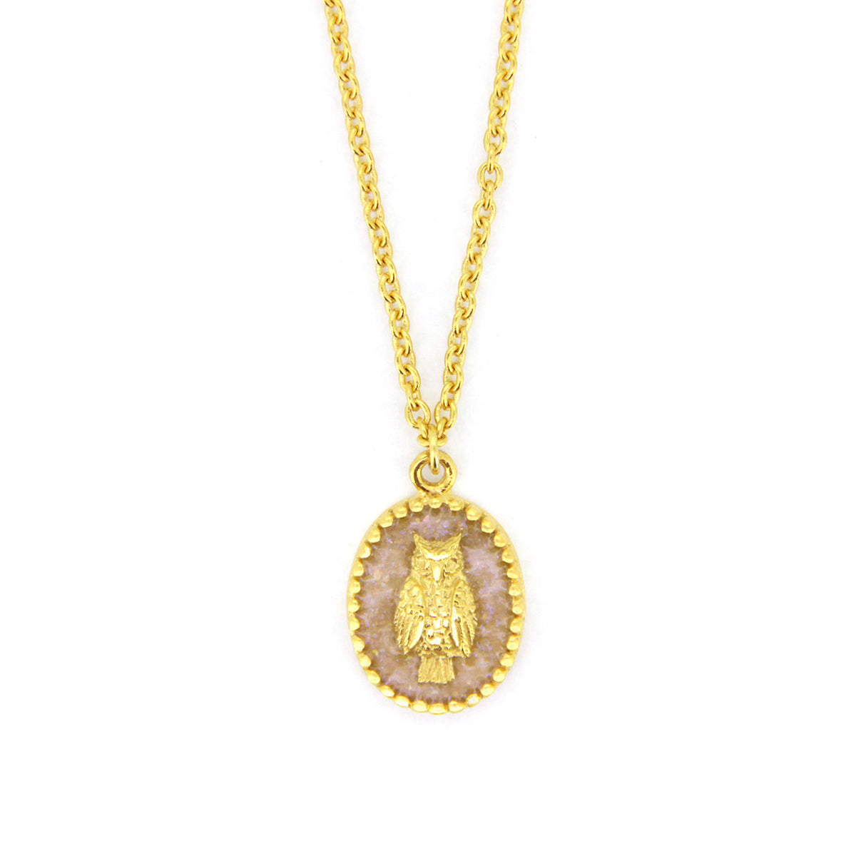 A gold necklace with oval charms showcasing a detailed owl design