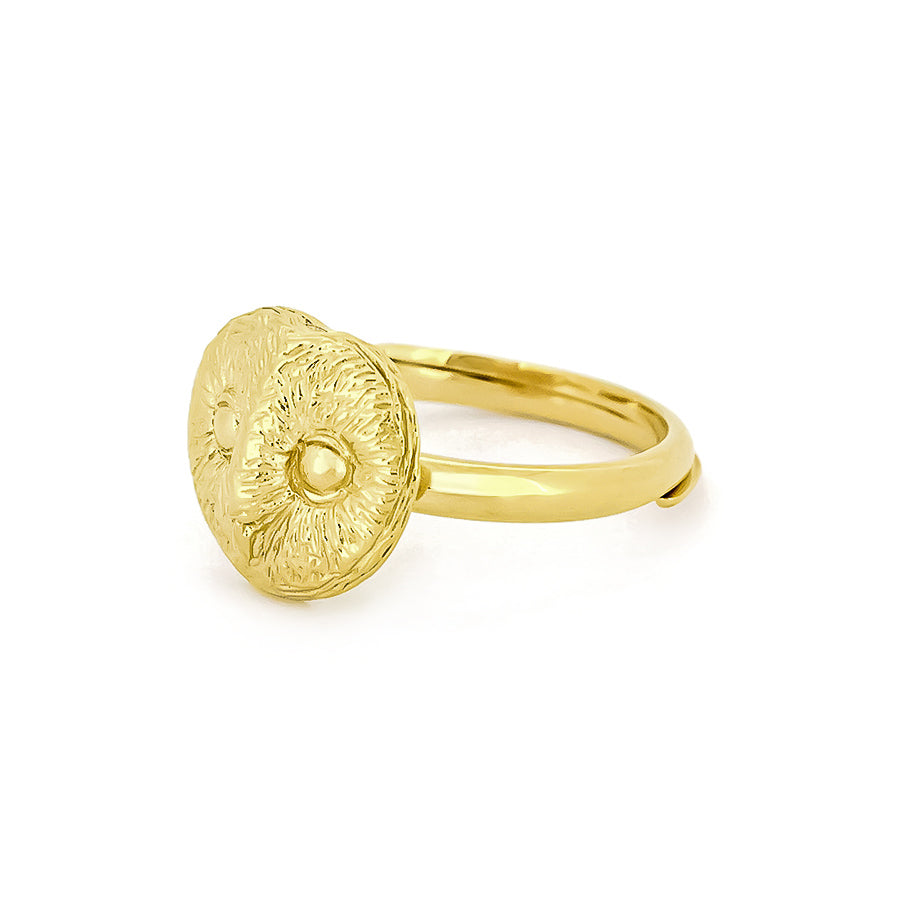 A beautiful gold ring featuring an intricately detailed owl face, showcasing round eyes and textured feathers.