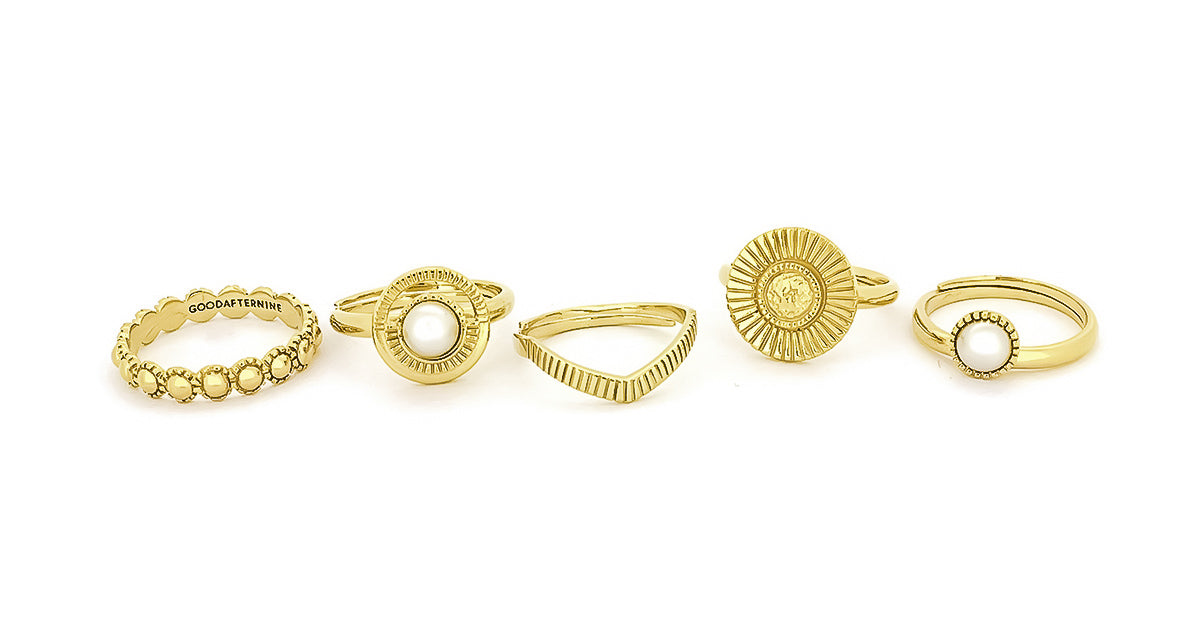 A collection of moon-inspired gold rings featuring various designs and textures.