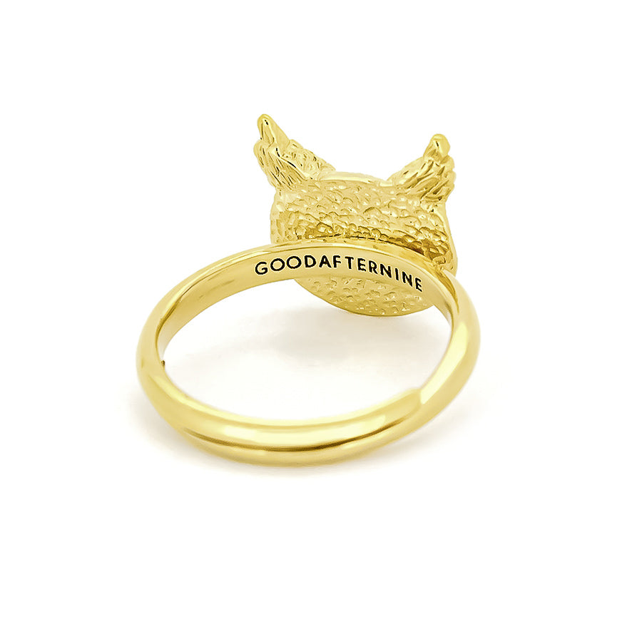 A beautiful gold ring featuring an intricately detailed owl face, showcasing round eyes and textured feathers.