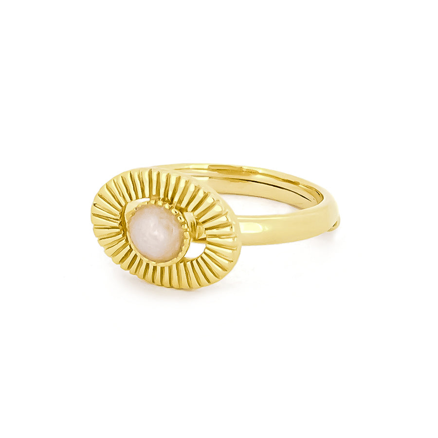 Gold ring with a central stone surrounded by textured rays, inspired by the moon.