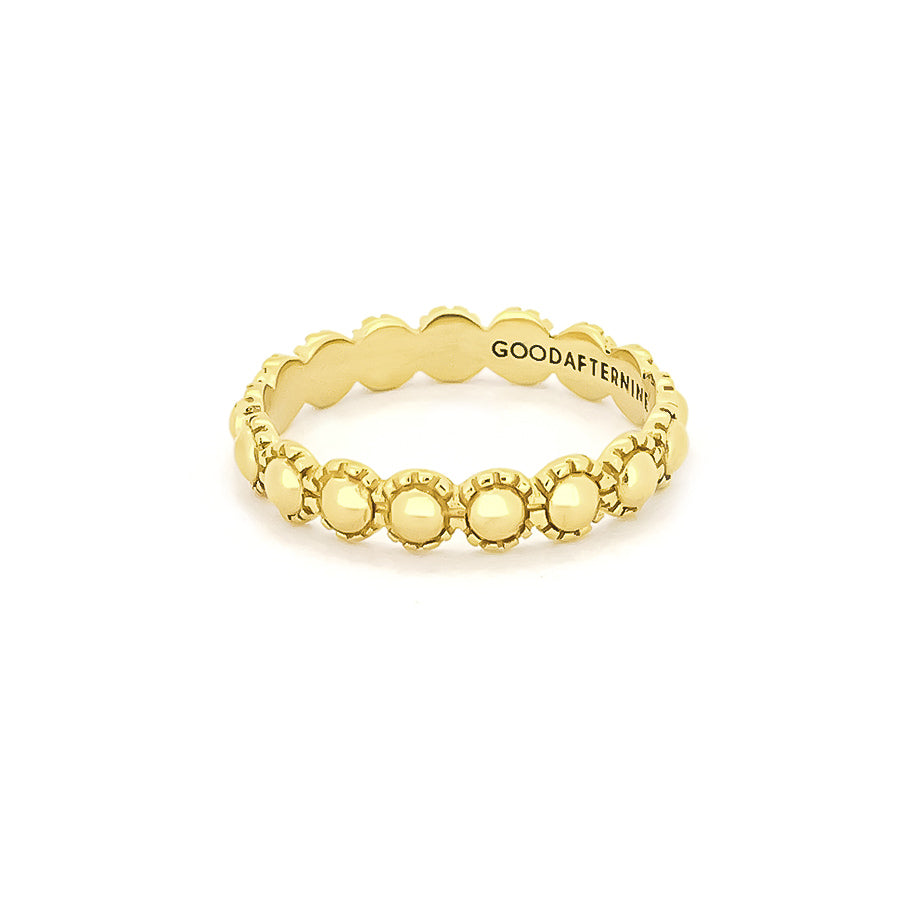 Gold ring featuring a circular, moon-inspired design with textured detailing.