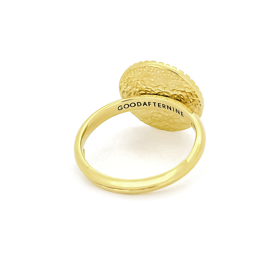 Beautiful gold ring with a textured, moon beam design and a central circular element.