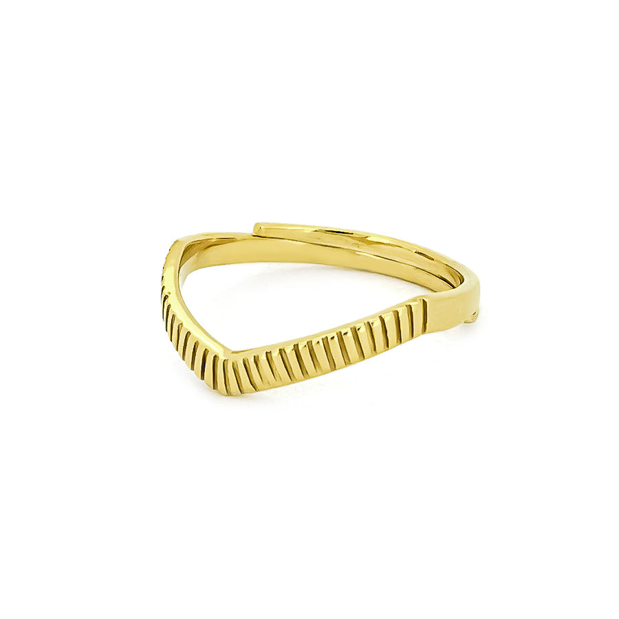 A gold ring features a unique v-shaped silhouette with a texture along its band, inspired by moon beams.