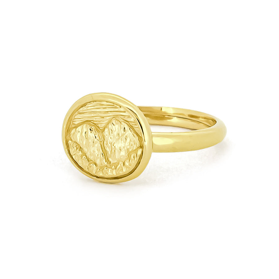 Beautiful gold ring displays an intricately engraved landscape of mountain