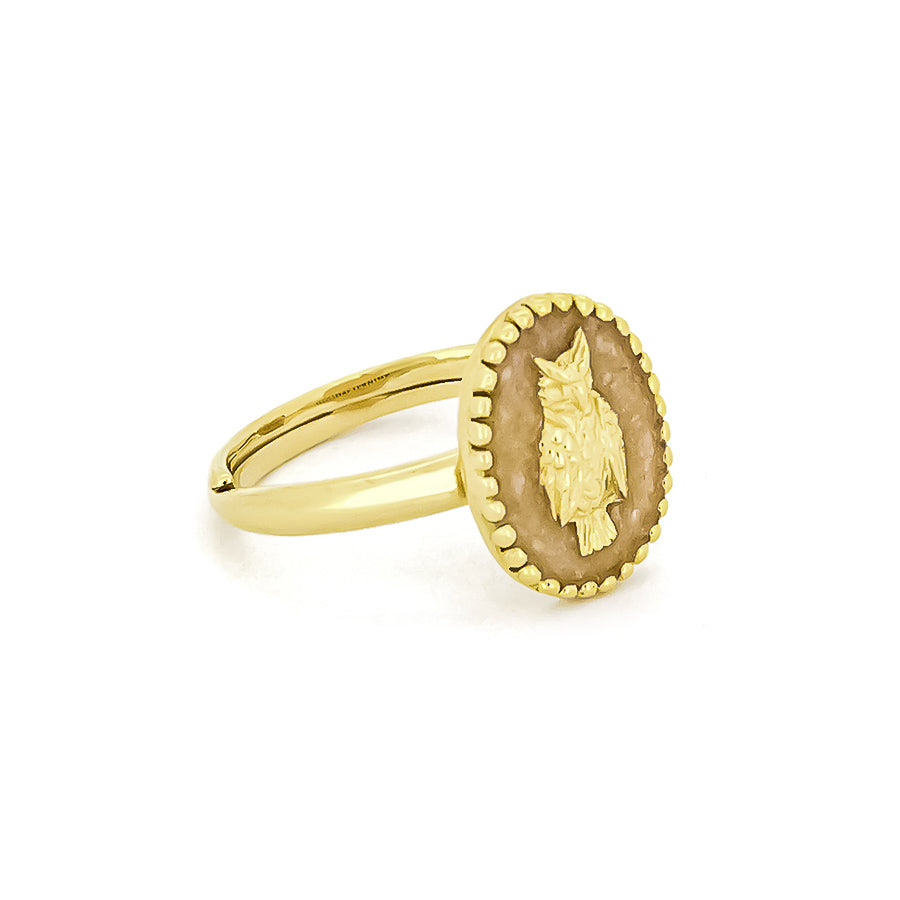 Beautiful gold ring featuring a carved owl set in an oval background.