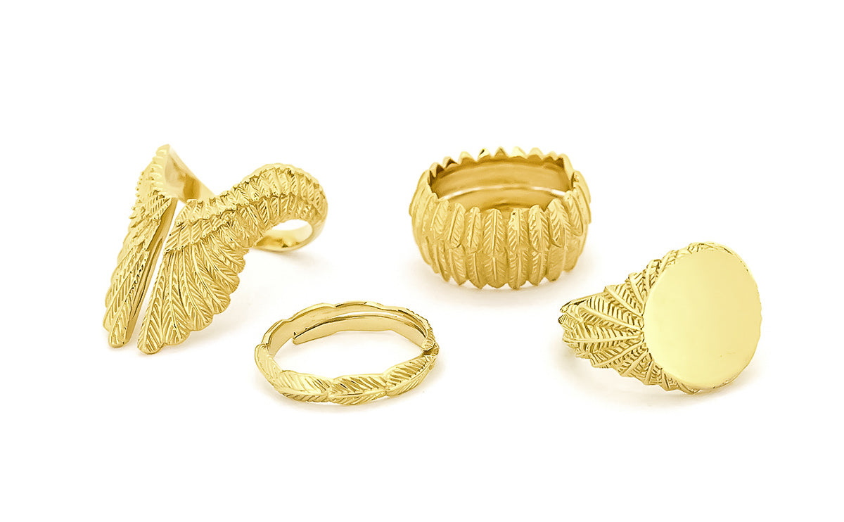 A collection of elegant gold rings with intricate feather designs.