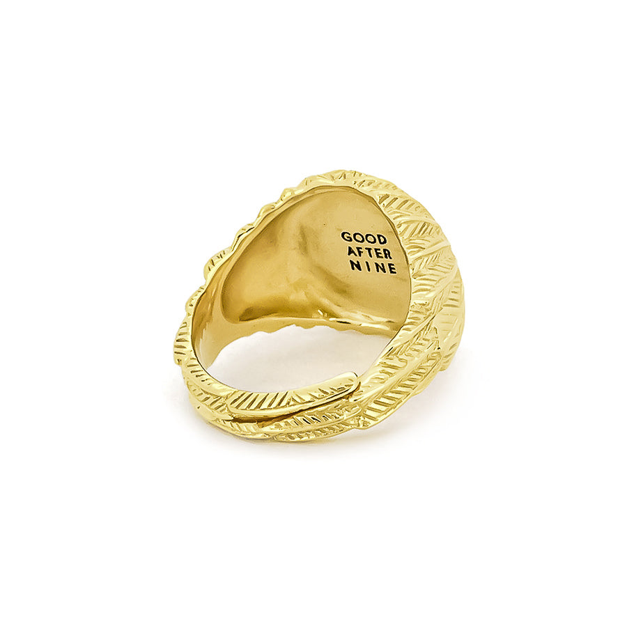 Elegant gold ring with a smooth circular top and ornate feather-patterned band.