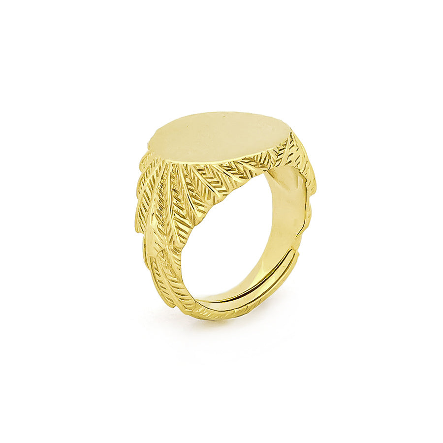 Handcrafted gold ring with a smooth circular top and ornate feather-patterned band.