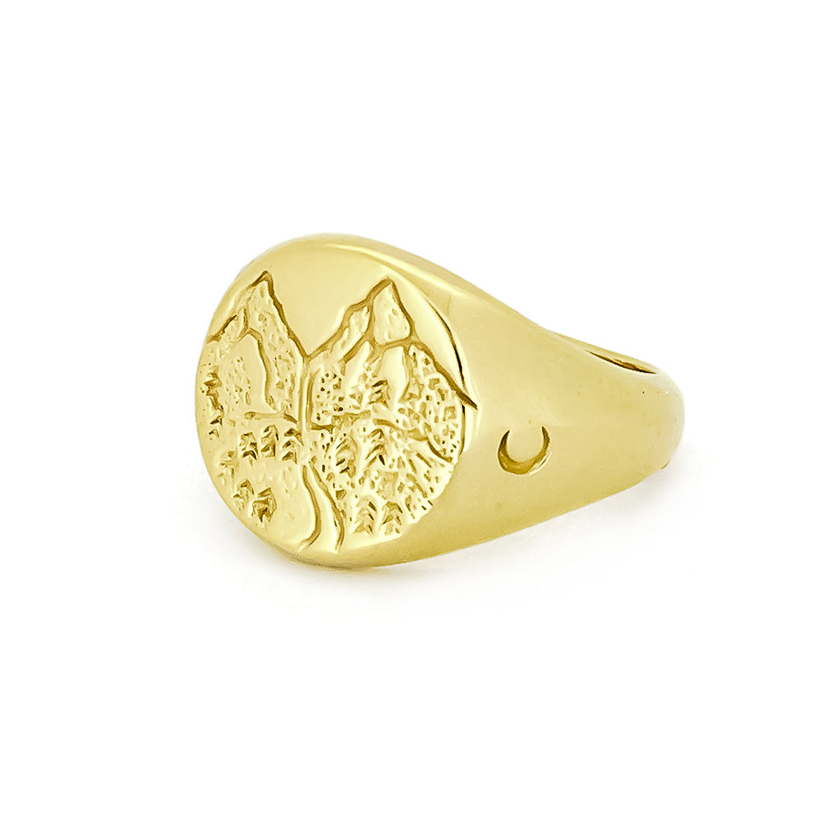 Gold ring with a textured mountain and moon design on the surface, perfect for nature lovers.