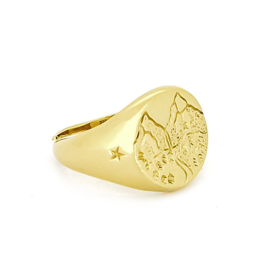 Gold ring with a textured mountain and star design on the surface, perfect for nature lovers.