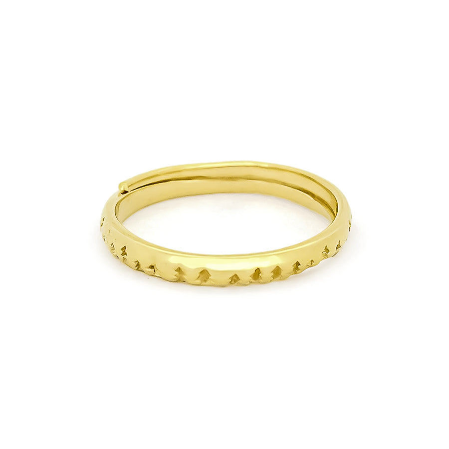 A golden stacking ring featuring a textured design of small trees, inspired by forest elements