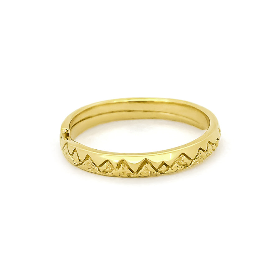 Beautiful gold ring with a jagged mountain design around the band.