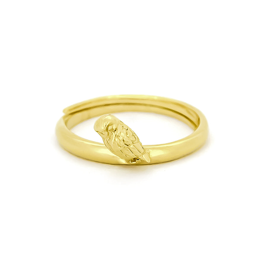 A gold ring with a delicate owl motif perched on one side, showcasing intricate detailing.