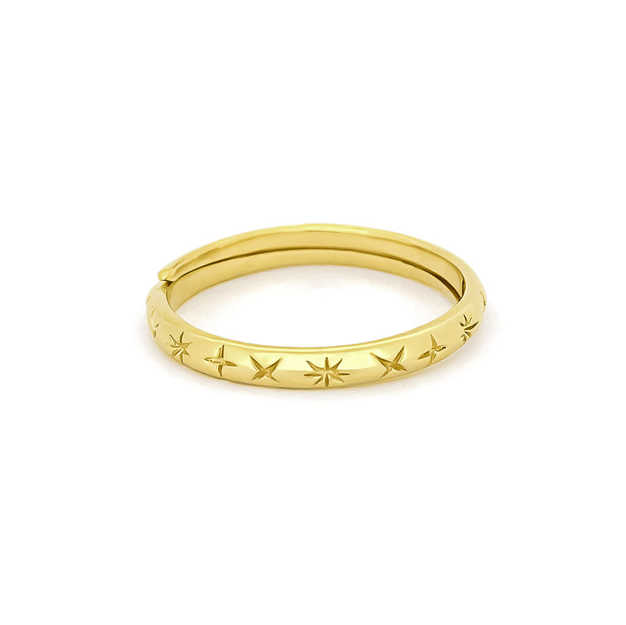 Charming gold ring featuring a series of carved star patterns around its band.