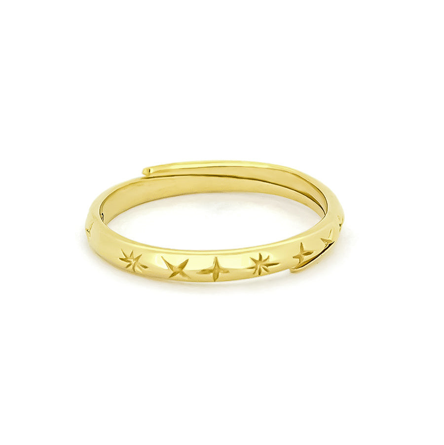 Gold star-patterned ring with a smooth band, inspired by nature.